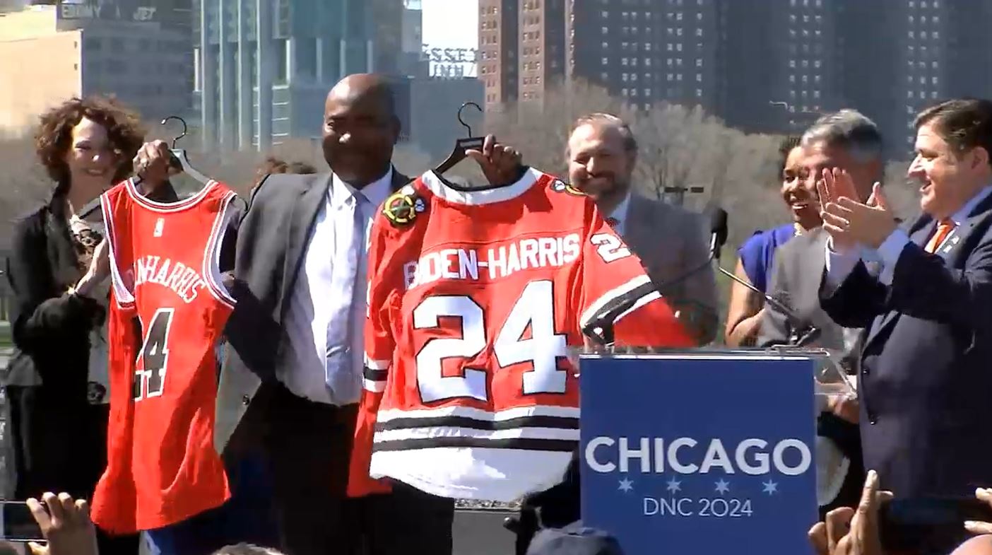 Democratic National Committee Chair Jaime Harrison holds Chicago Bulls and Blackhawks jerseys with a Biden-Harris 2024 theme at a news conference announcing the 2024 Democratic National Convention will be hosted in Chicago.  Democratic National Committee Chair Jaime Harrison speaks at a news conference announcing the 2024 Democratic National Convention will be hosted in Chicago. (Credit: Blueroomstream.com)