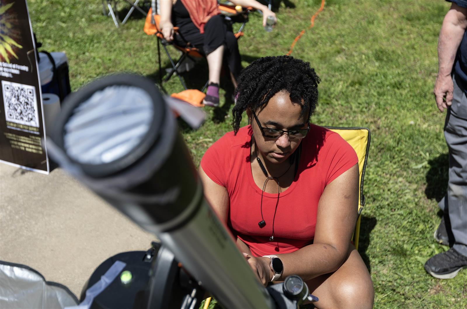 Hontas Farmer looks at her solar telescope to broadcast the eclipse April 8, 2024 in Makanda, Illinois.