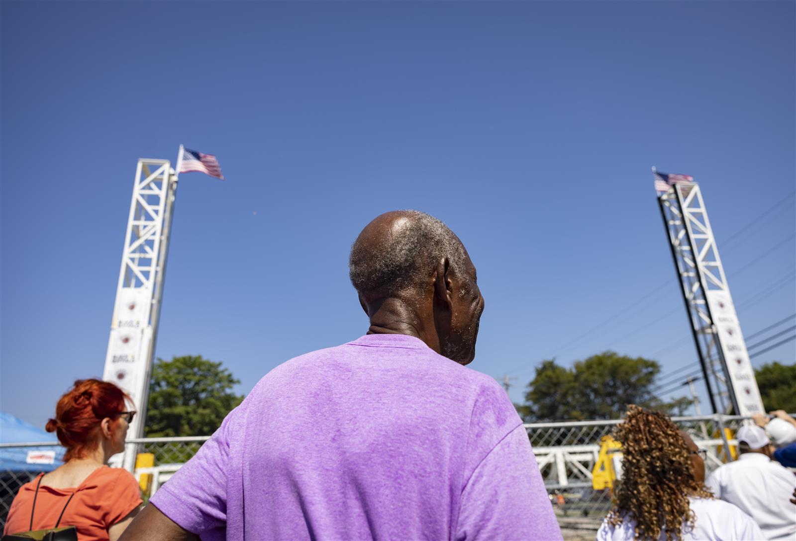 a crowd watches the construction of the 3D printer