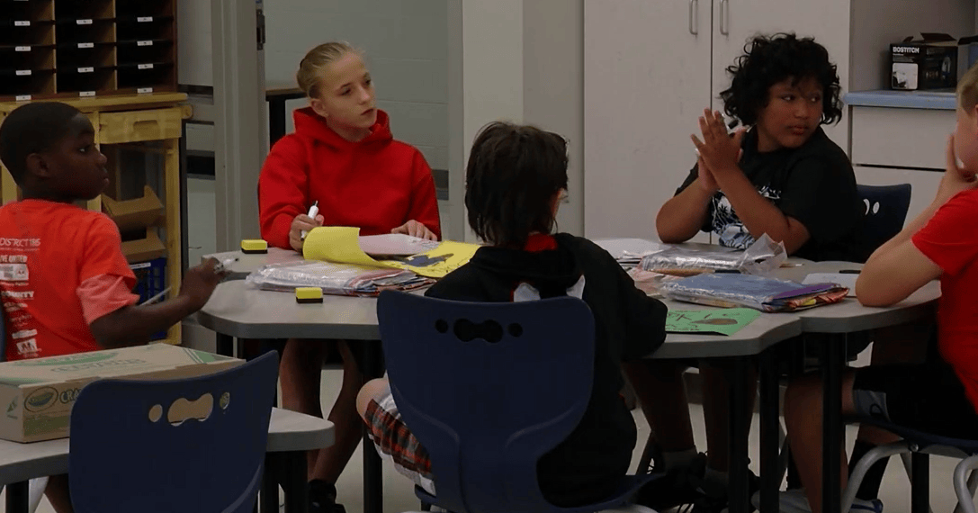 Illinois middle students seated at a table