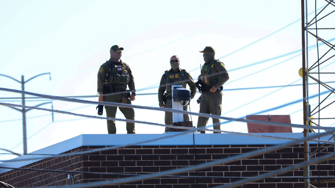 Three men in Customs and Border Protection uniforms