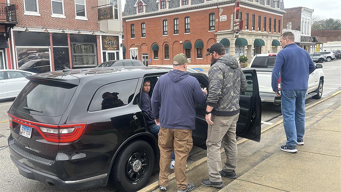Jose Jeronimo Guardian in back of unmarked SUV.