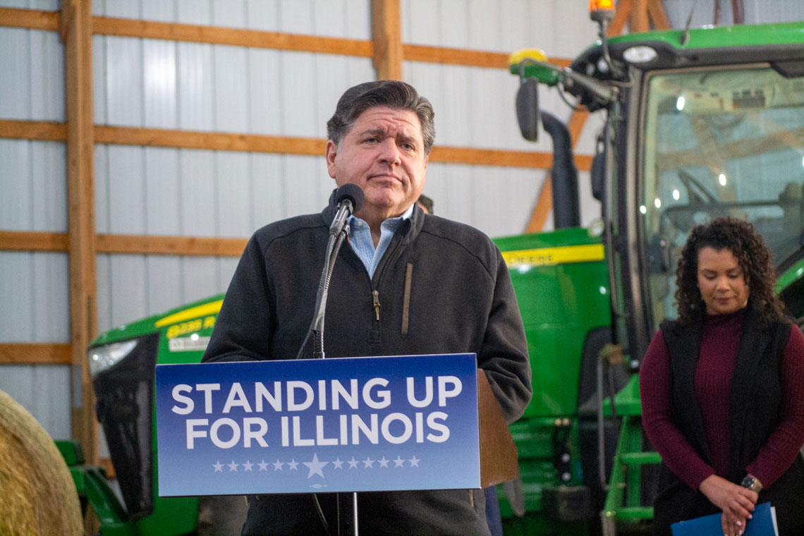 JB Pritzker speak in front of farm equipment