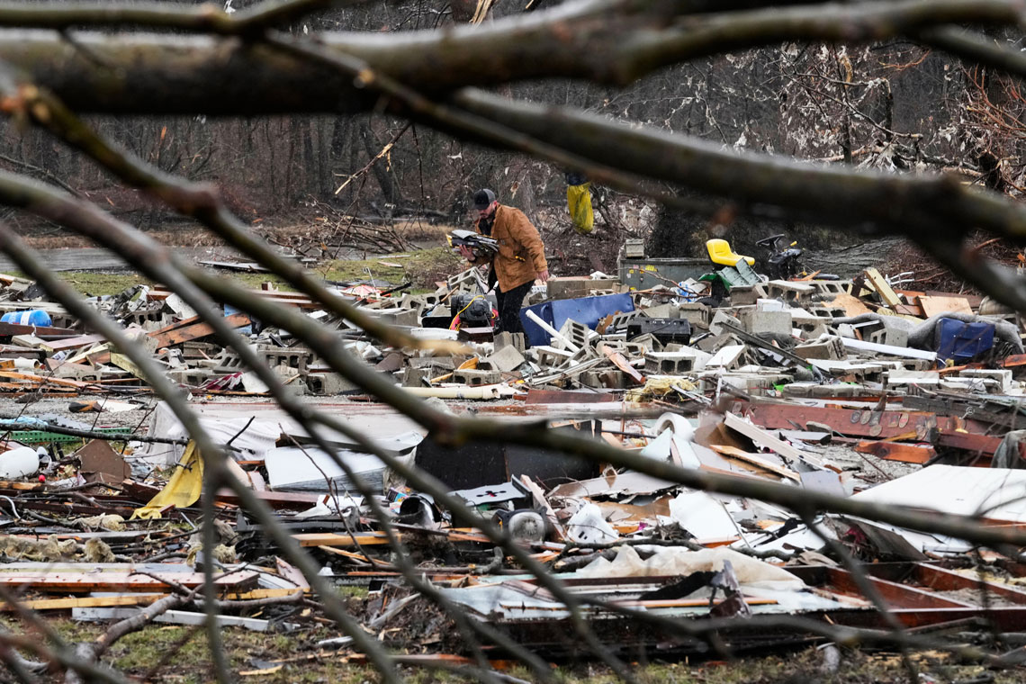 Person searching through storm debris.