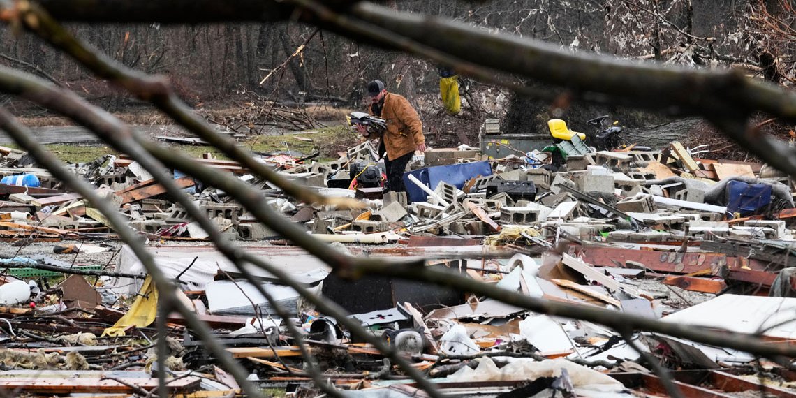 Person searching through storm debris.