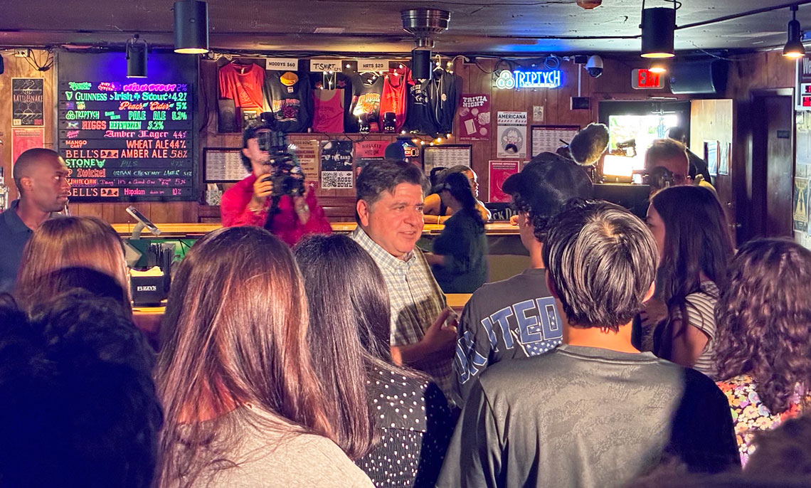 JB Pritzker speaks with students in a Urbana tavern.